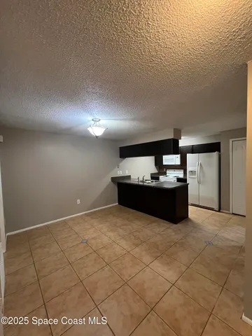 a kitchen with a refrigerator and microwave