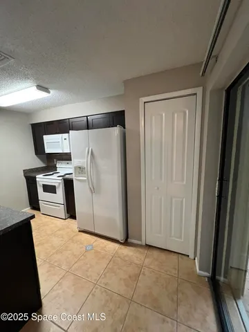 a kitchen with granite countertop a stove and a sink