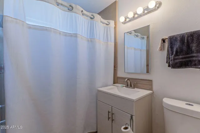 a bedroom with a bed and a dresser in it