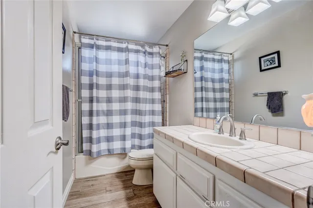 a bathroom with a sink a toilet a shower and a mirror