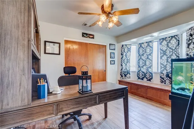a view of a dining room with furniture a chandelier and wooden floor