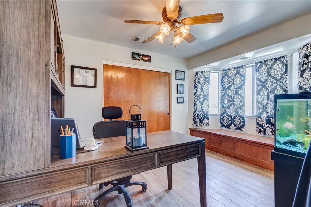 10163 Ponderosa Road Pinon Hills, CA 92372 - Photo 16 of 35 a view of a dining room with furniture a chandelier and wooden floor