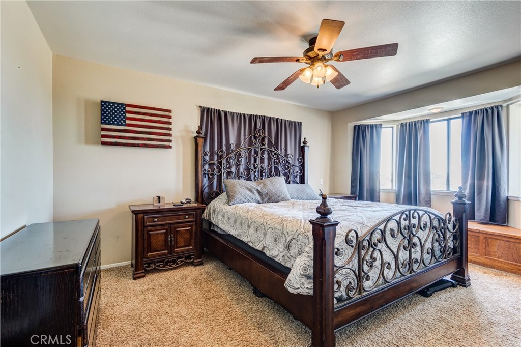 10163 Ponderosa Road Pinon Hills, CA 92372 - Photo 20 of 35 a bed sitting in a spacious bedroom next to a window