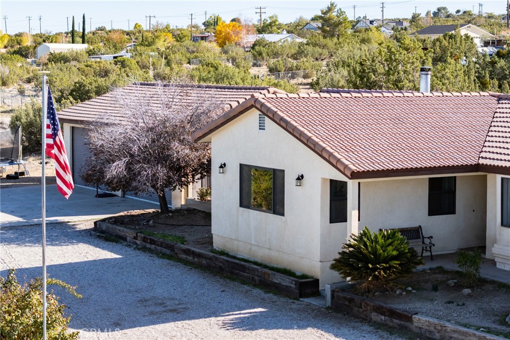 10163 Ponderosa Road Pinon Hills, CA 92372 - Photo 2 of 35 a house with trees in the background