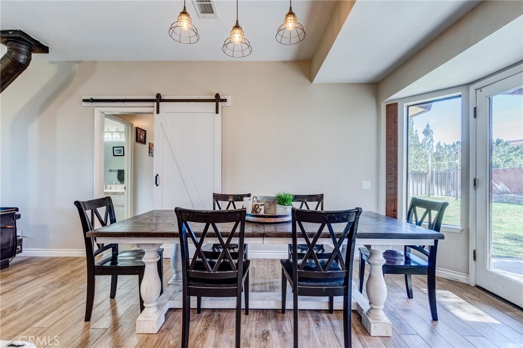 10163 Ponderosa Road Pinon Hills, CA 92372 - Photo 10 of 35 a view of a dining room with furniture and wooden floor