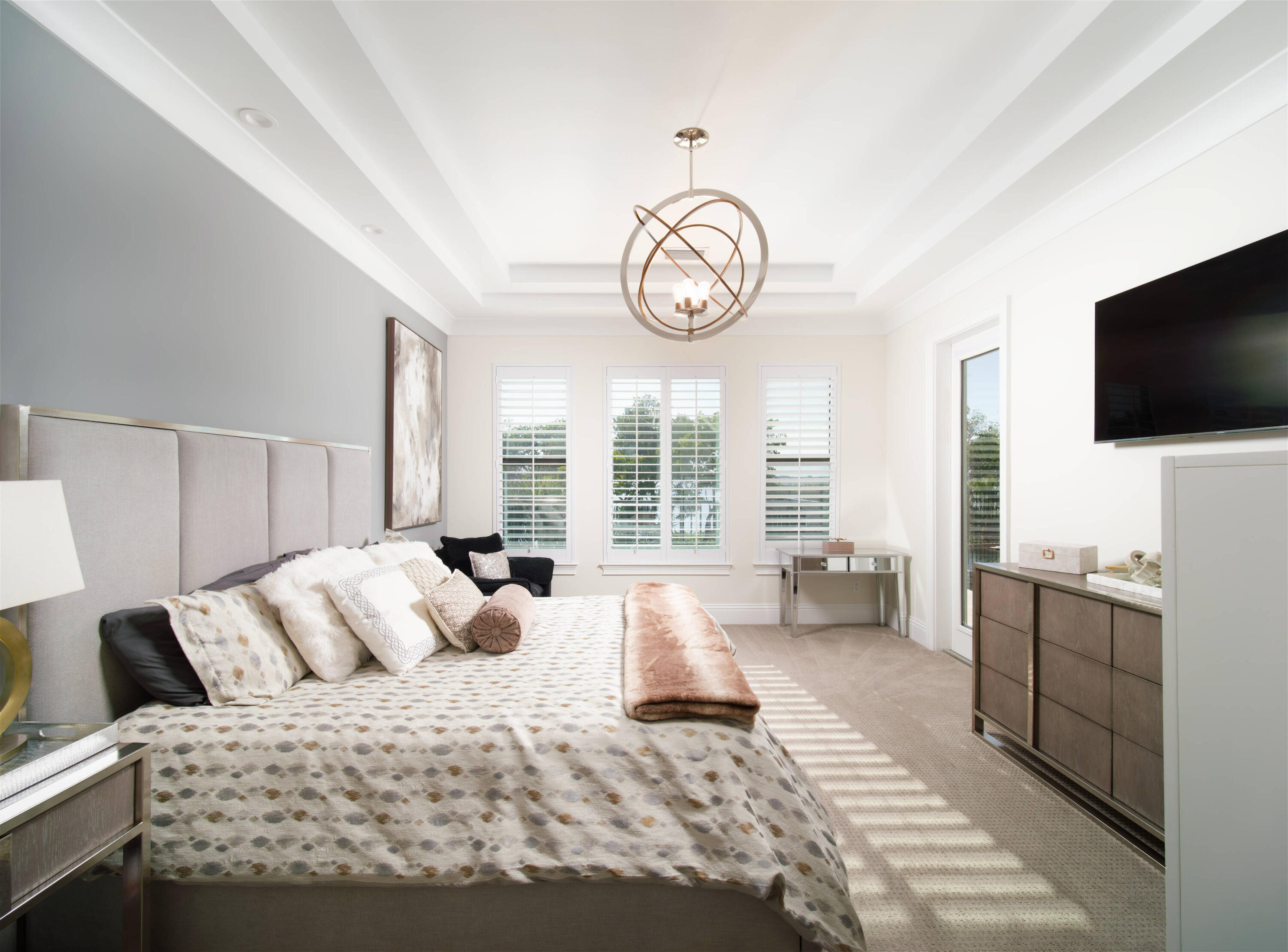 7683 Pelican Pointe Drive Jensen Beach, FL 34957 - Photo 18 of 40 a spacious bedroom with a large bed and a flat screen tv