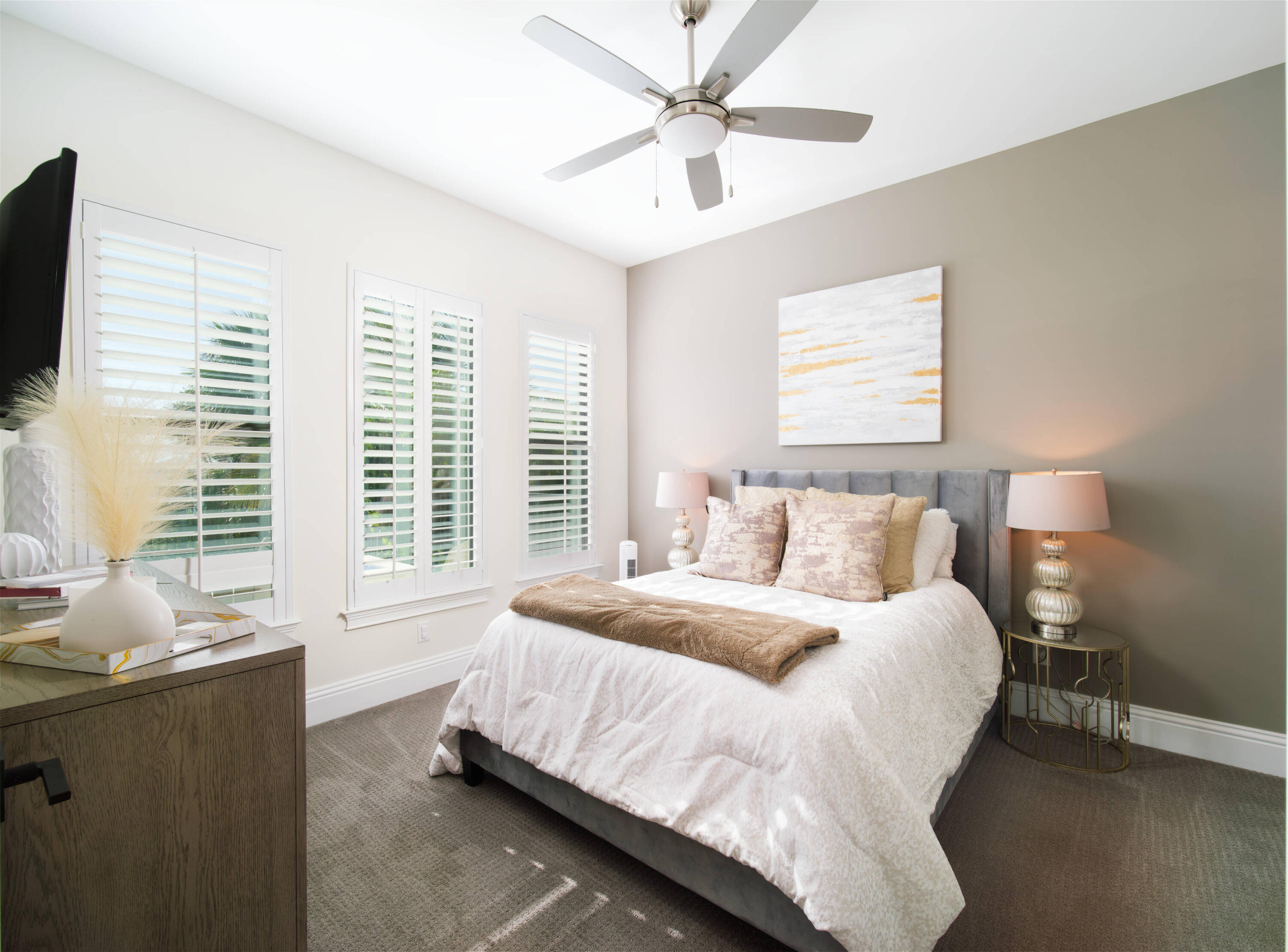 7683 Pelican Pointe Drive Jensen Beach, FL 34957 - Photo 20 of 40 a spacious bedroom with a bed and a flat screen tv