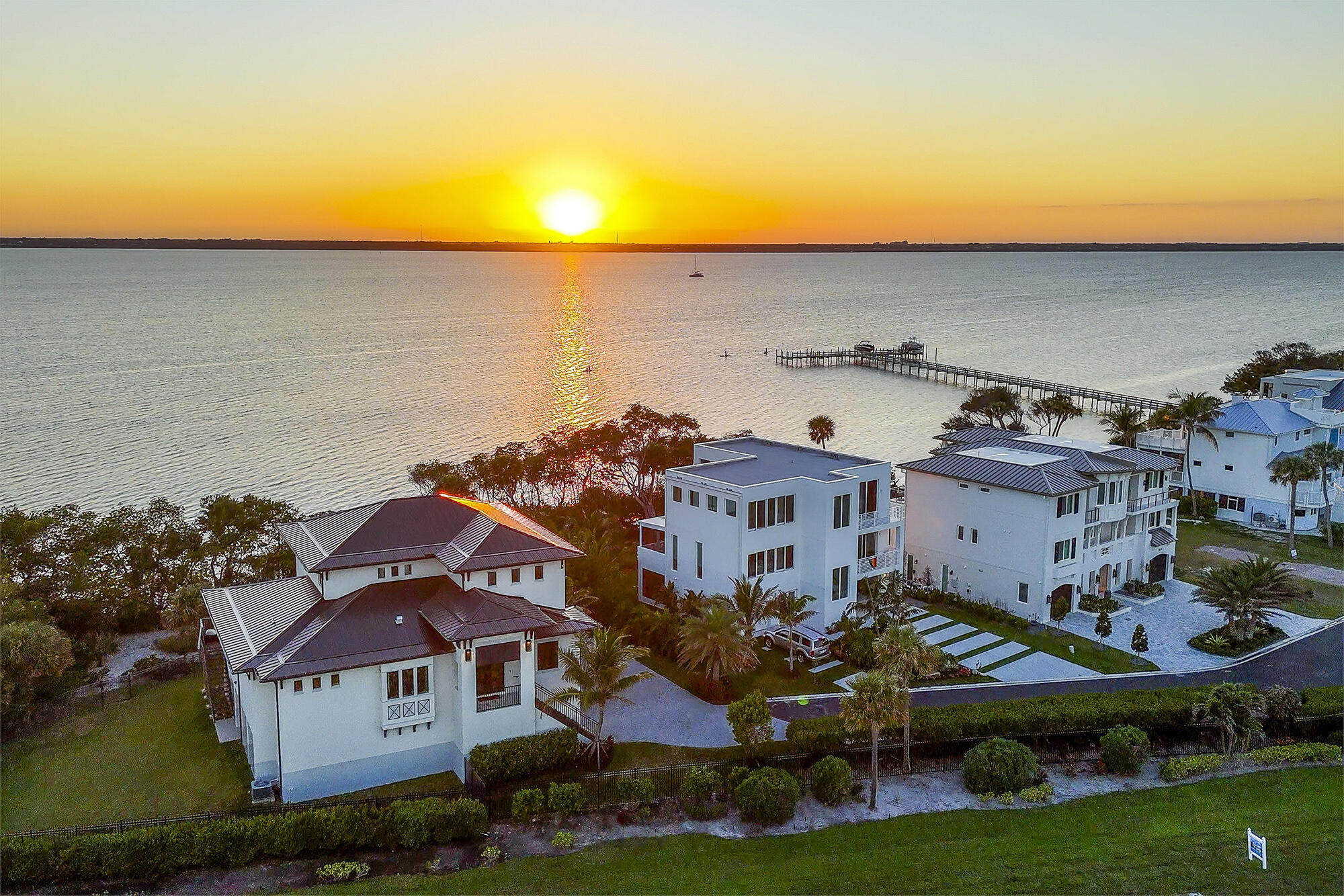 7683 Pelican Pointe Drive Jensen Beach, FL 34957 - Photo 2 of 40 an aerial view of multiple houses with yard