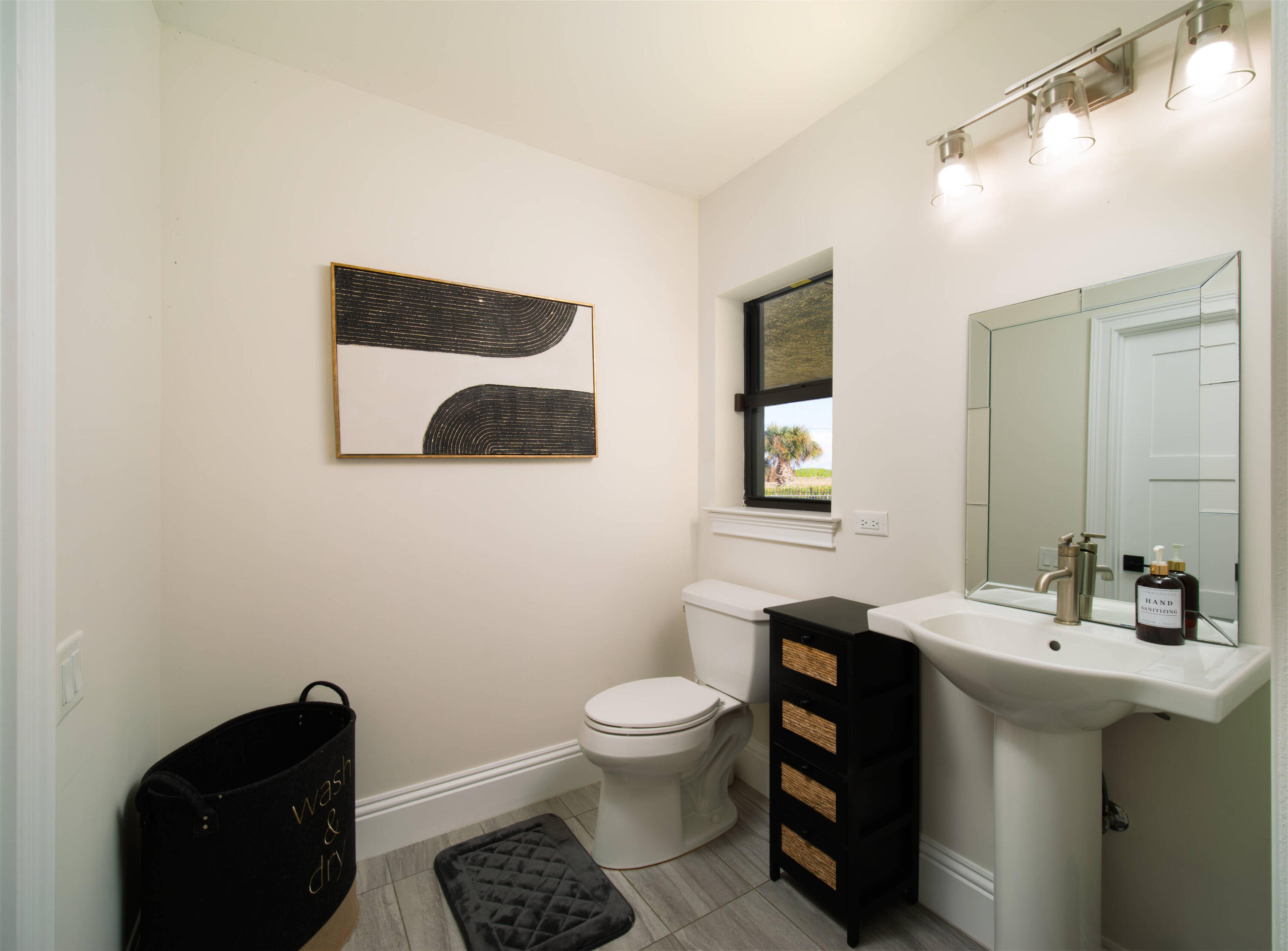 7683 Pelican Pointe Drive Jensen Beach, FL 34957 - Photo 25 of 40 a bathroom with a toilet a sink and mirror