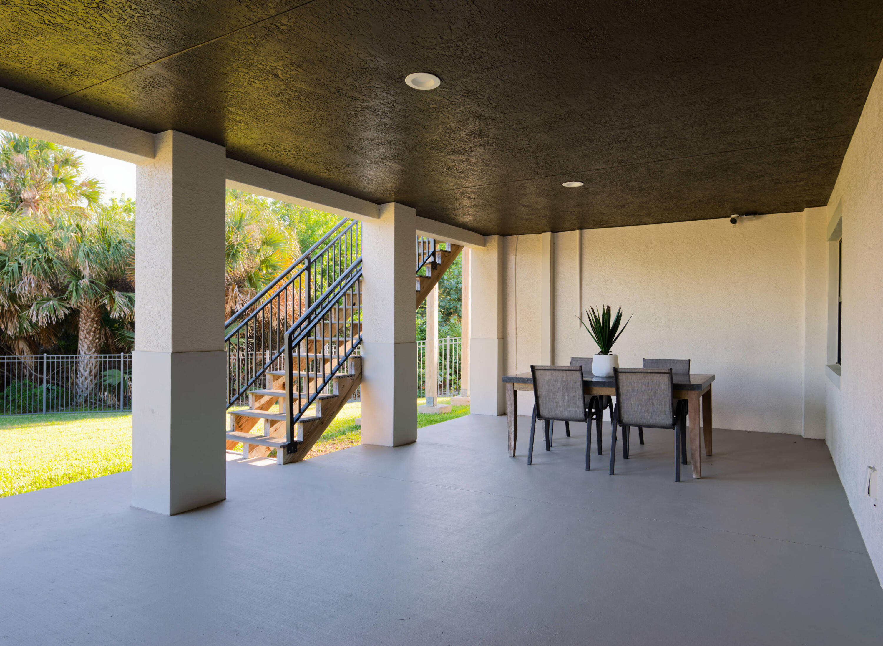 7683 Pelican Pointe Drive Jensen Beach, FL 34957 - Photo 30 of 40 a view of a porch with chairs and backyard