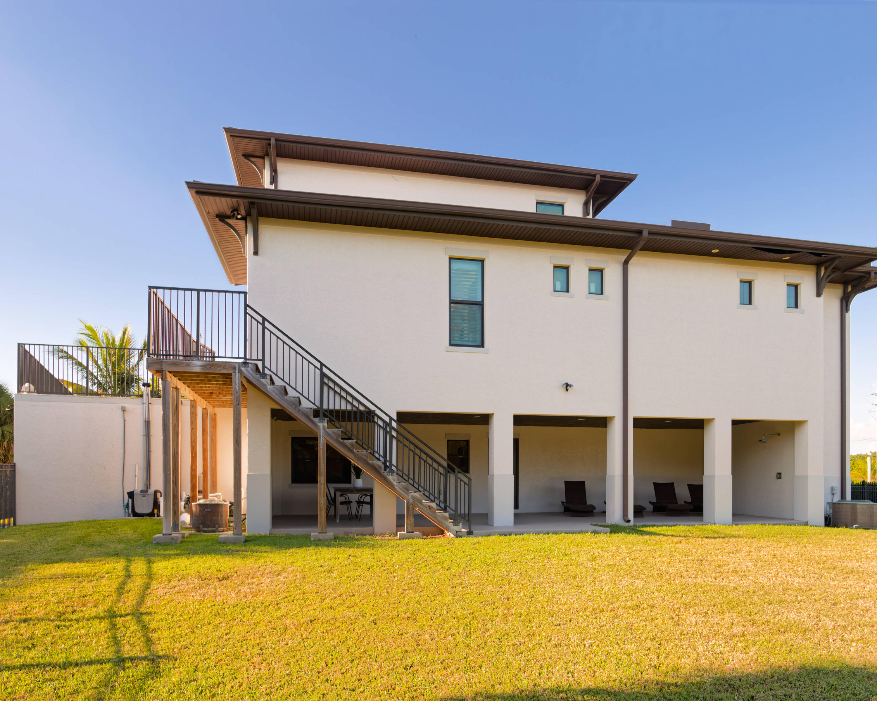 7683 Pelican Pointe Drive Jensen Beach, FL 34957 - Photo 35 of 40 a view of a house with pool and a yard
