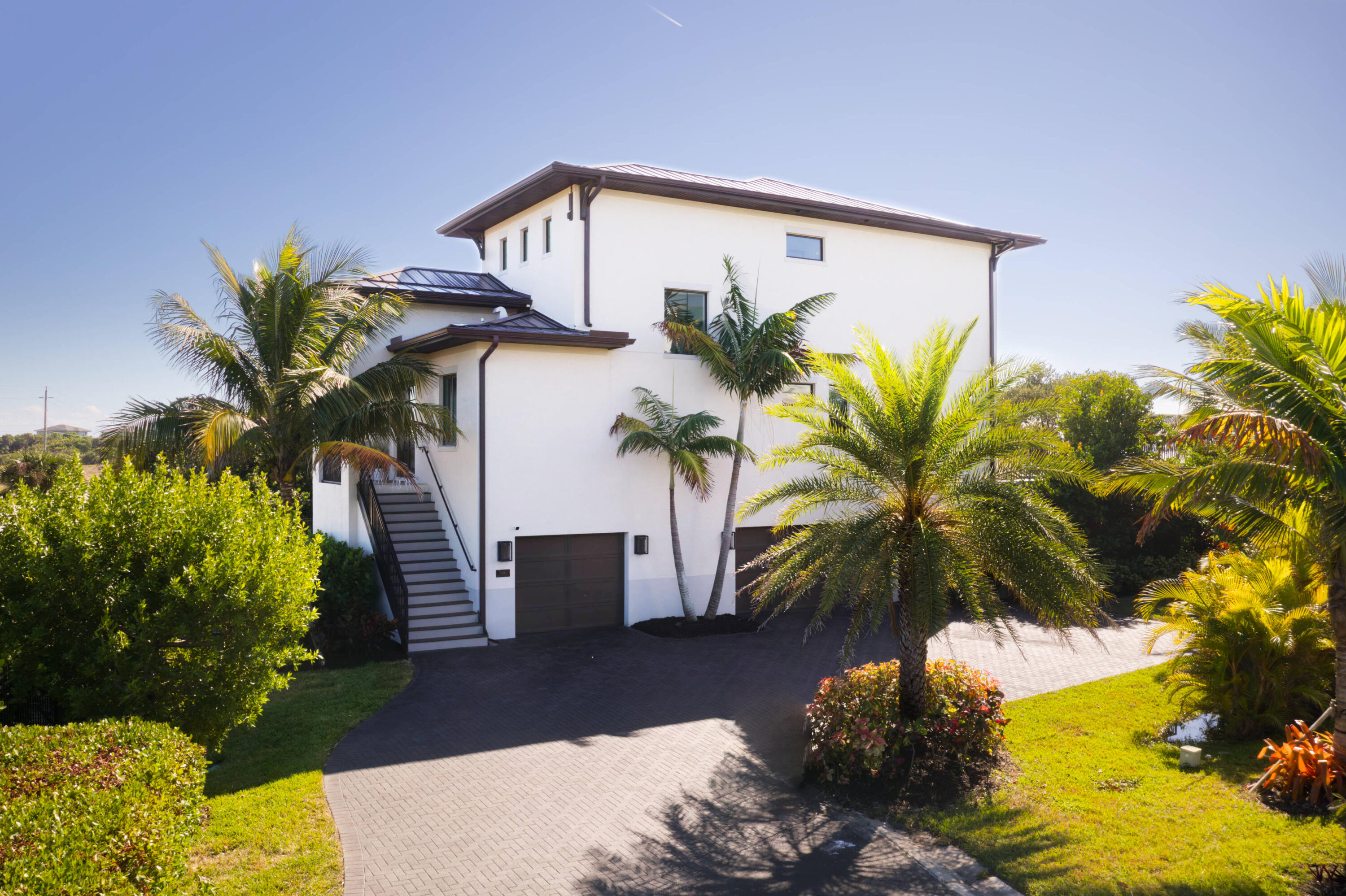 7683 Pelican Pointe Drive Jensen Beach, FL 34957 - Photo 5 of 40 a front view of a house with a yard