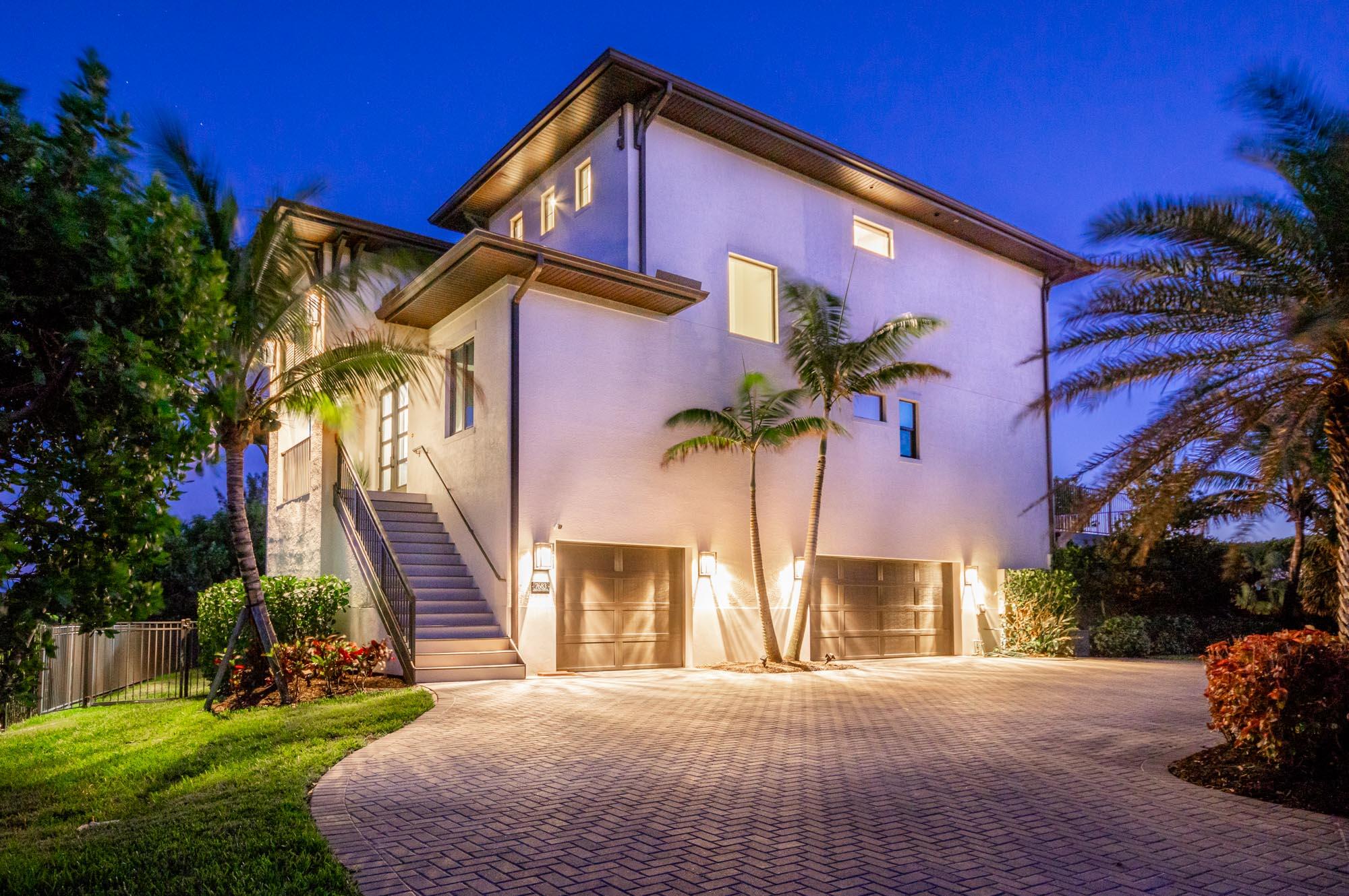 7683 Pelican Pointe Drive Jensen Beach, FL 34957 - Photo 6 of 40 a front view of a house with a yard and garage