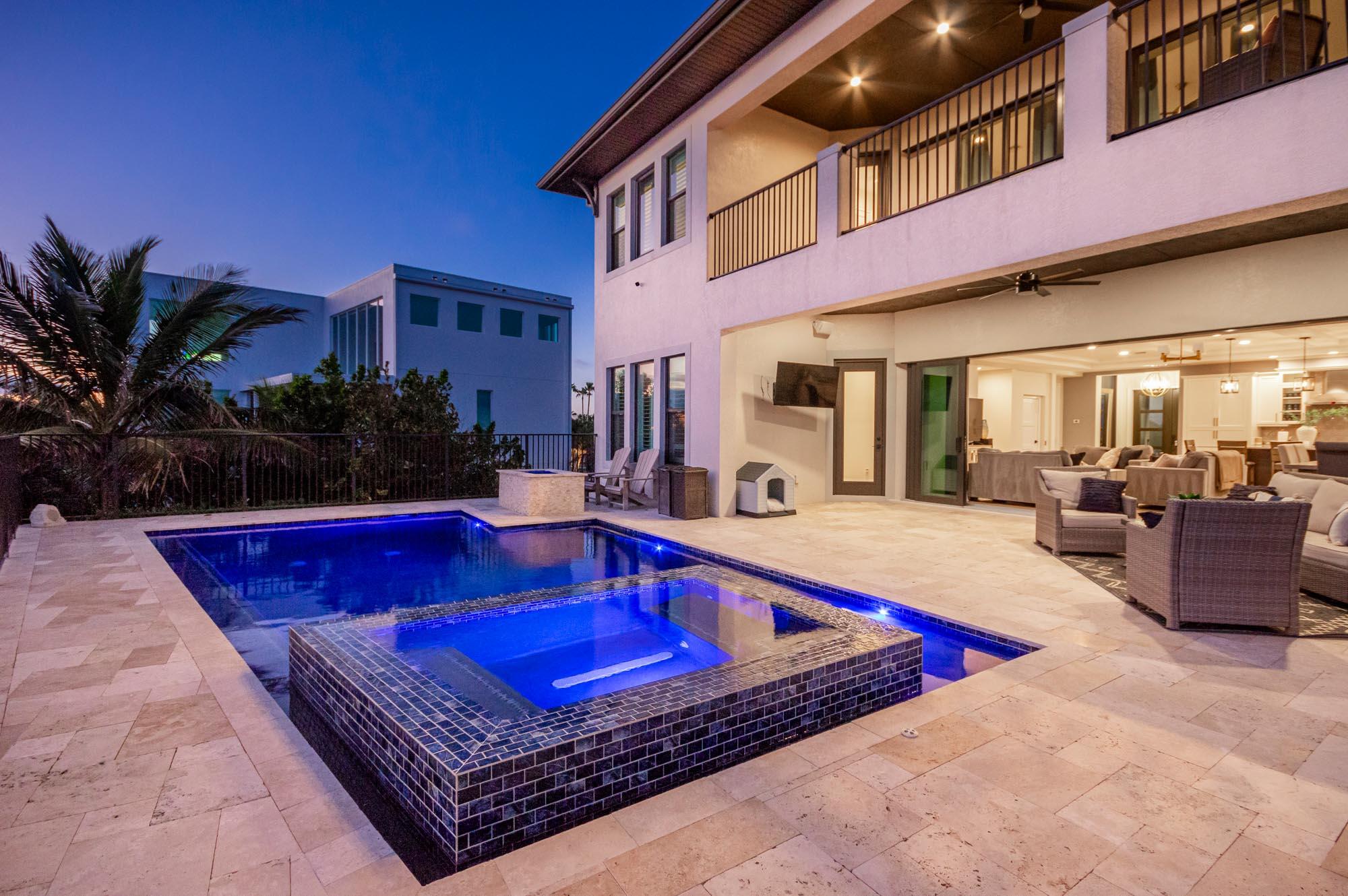 7683 Pelican Pointe Drive Jensen Beach, FL 34957 - Photo 9 of 40 a swimming pool with outdoor seating