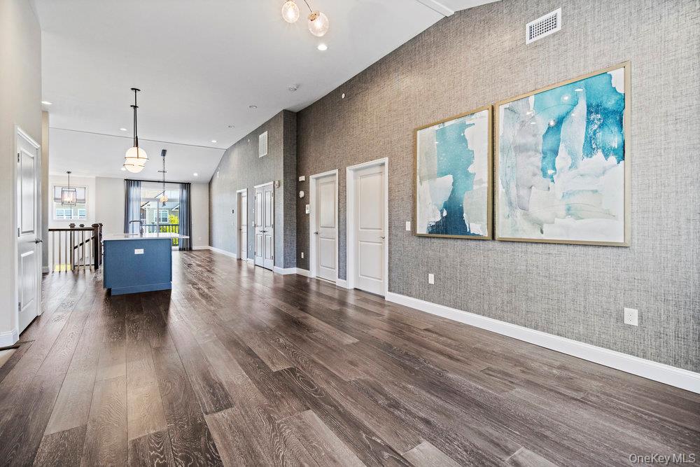 295 Silver Timber Drive Yaphank, NY 11980 - Photo 13 of 50 a view of a big room with wooden floor and windows