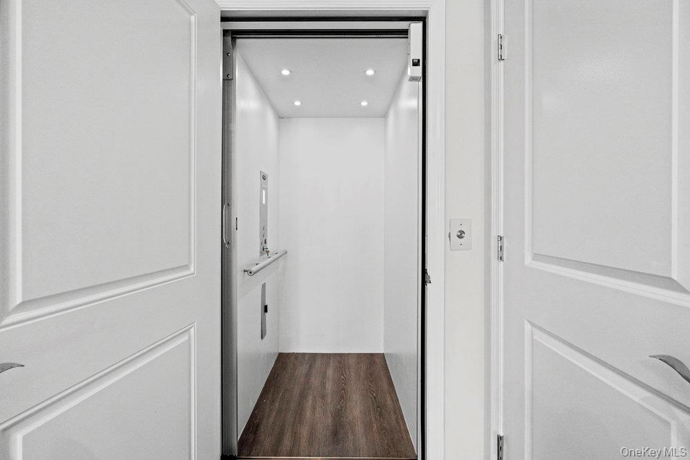 295 Silver Timber Drive Yaphank, NY 11980 - Photo 15 of 50 a view of a hallway with wooden floor