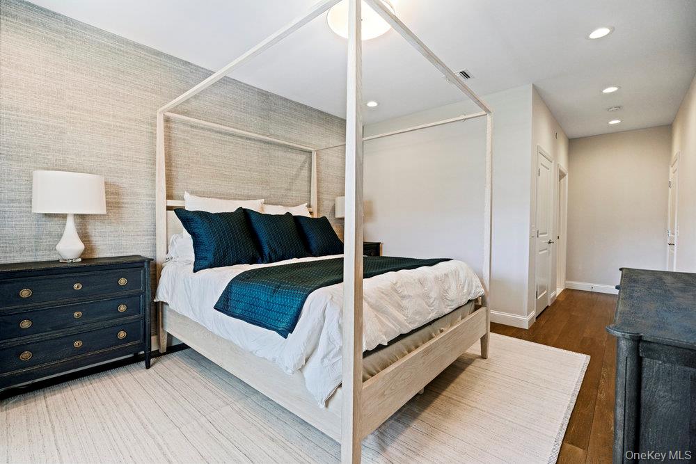 295 Silver Timber Drive Yaphank, NY 11980 - Photo 18 of 50 a bedroom with a bed and a night stand