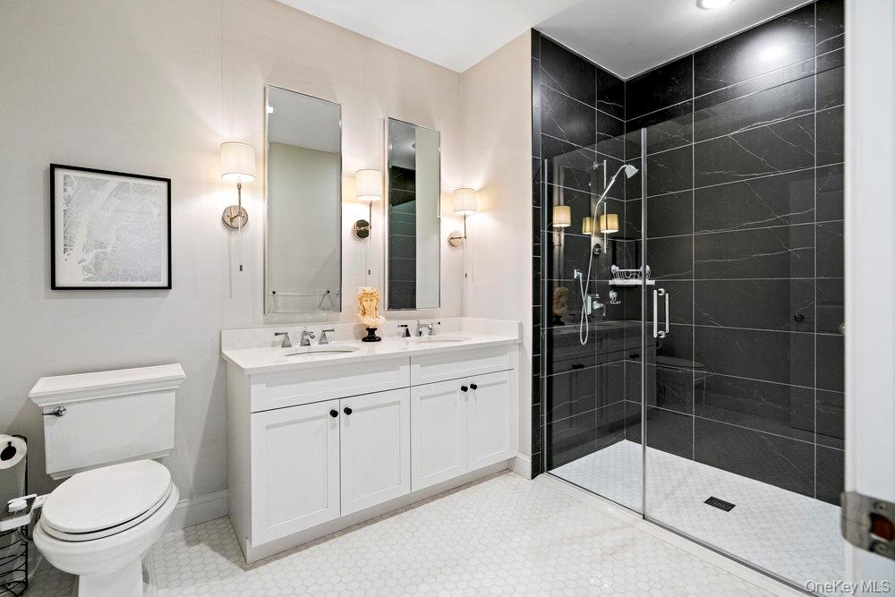 295 Silver Timber Drive Yaphank, NY 11980 - Photo 20 of 50 a bathroom with a sink toilet and shower