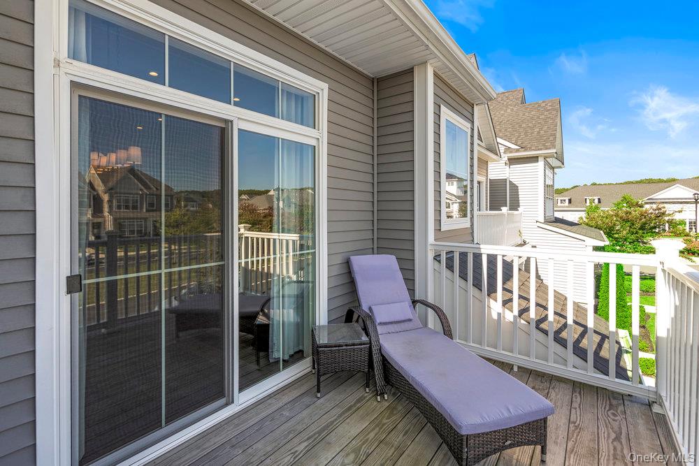 295 Silver Timber Drive Yaphank, NY 11980 - Photo 22 of 50 a view of a deck with two chair and wooden floor