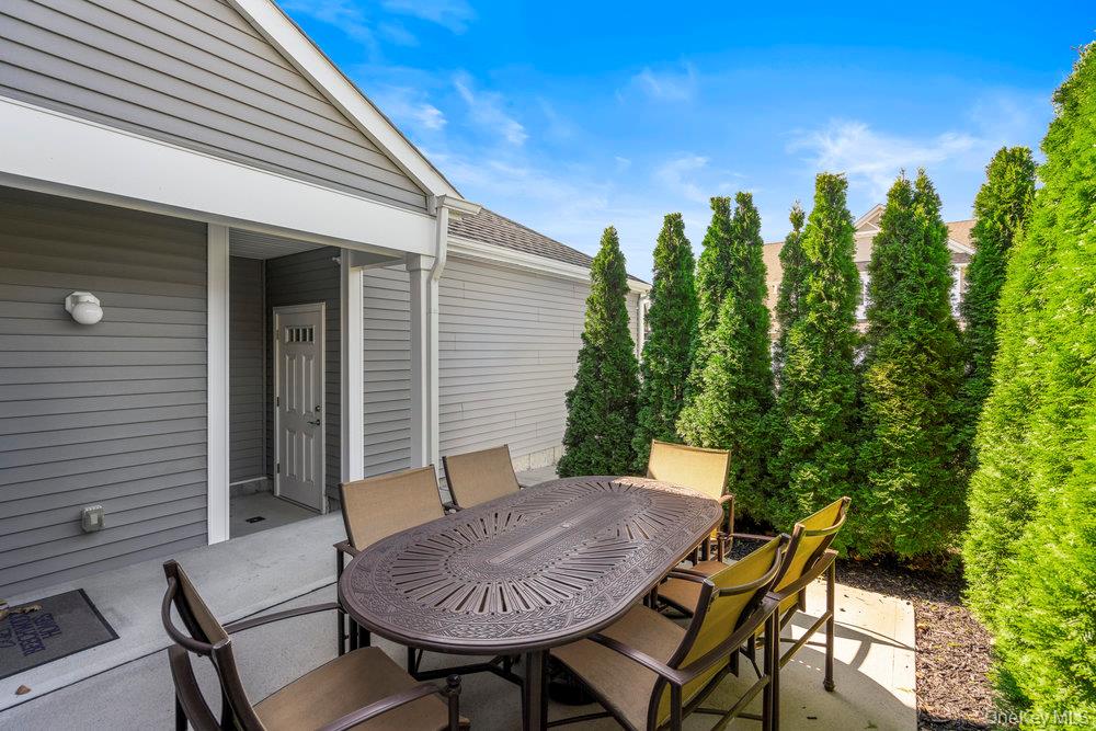 295 Silver Timber Drive Yaphank, NY 11980 - Photo 23 of 50 a view of a chairs and table in patio