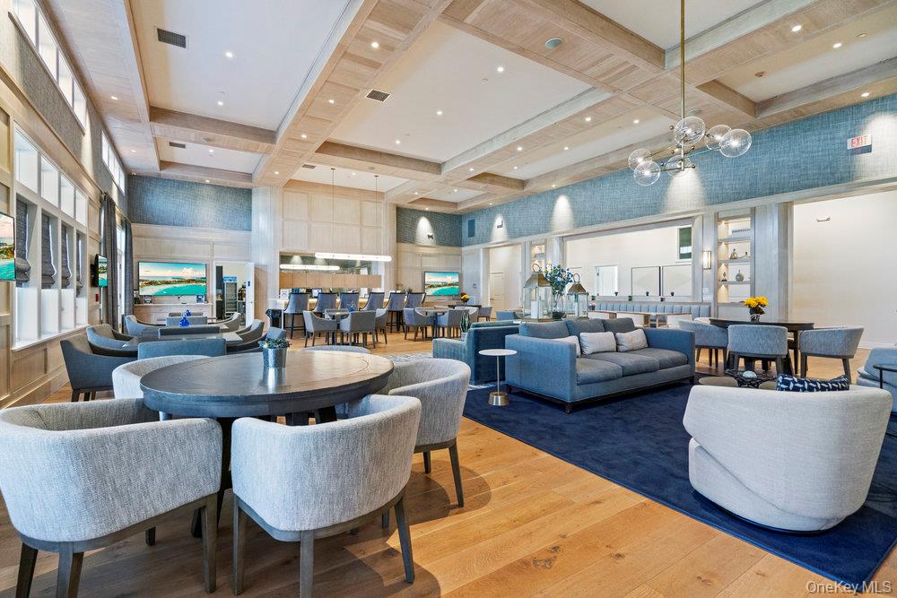 295 Silver Timber Drive Yaphank, NY 11980 - Photo 29 of 50 a living room with furniture and a chandelier