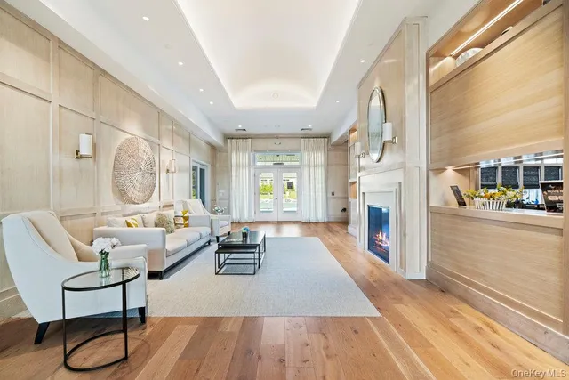 a living room with lots of furniture and view of kitchen