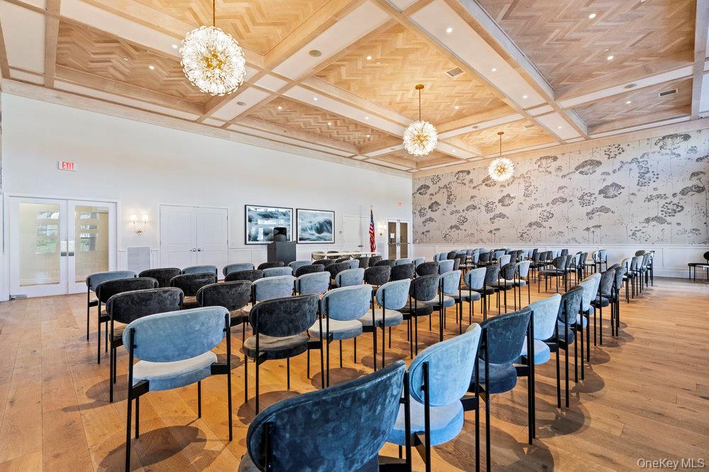 295 Silver Timber Drive Yaphank, NY 11980 - Photo 34 of 50 a living room with lots of furniture and a chandelier