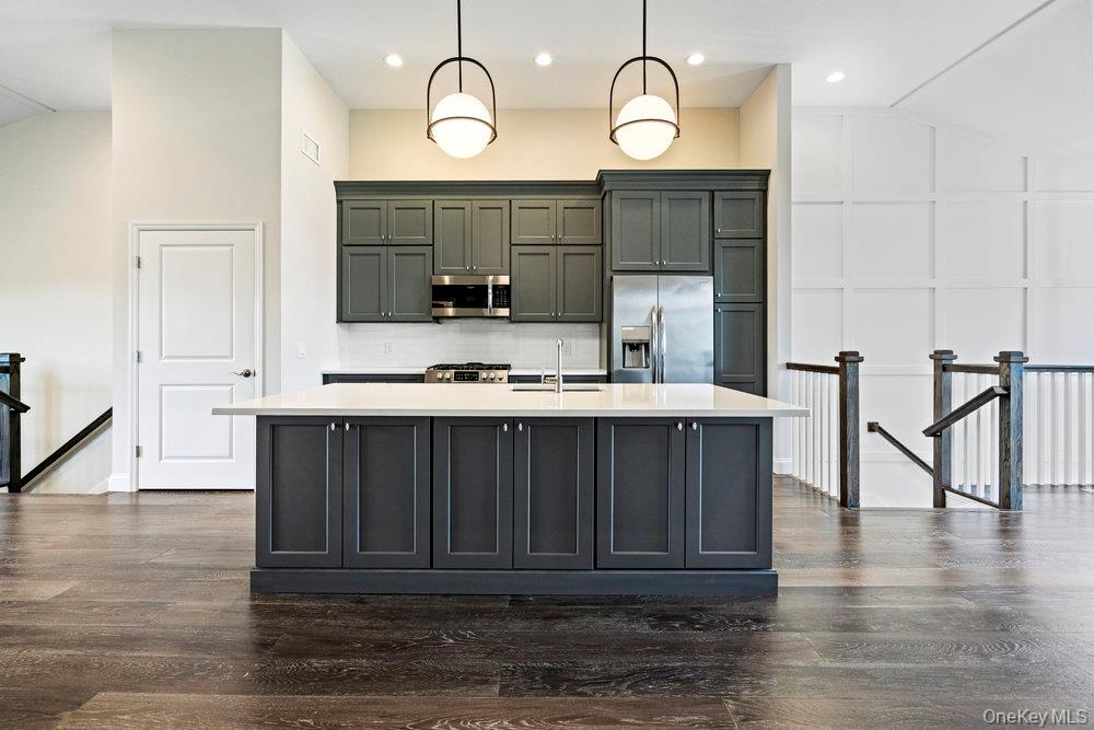 295 Silver Timber Drive Yaphank, NY 11980 - Photo 4 of 50 a view of kitchen with cabinets and wooden floor