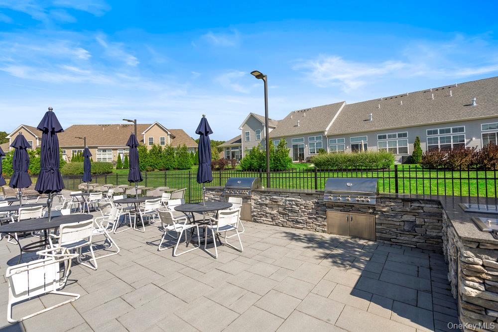 295 Silver Timber Drive Yaphank, NY 11980 - Photo 39 of 50 a view of a big yard with table and chairs in patio
