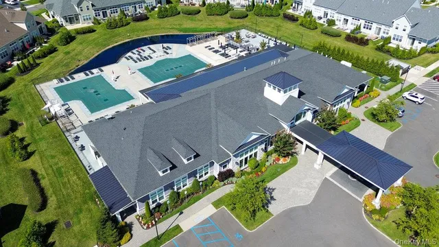 an aerial view of a house with a yard and lake view