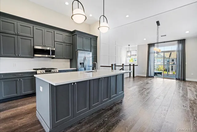 a kitchen with a sink microwave and cabinets