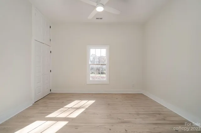 an empty room with wooden floor