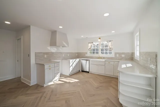 a large kitchen with kitchen island a sink stainless steel appliances and cabinets