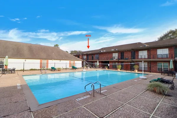a view of swimming pool with outdoor seating