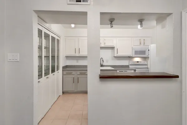 a kitchen with white cabinets