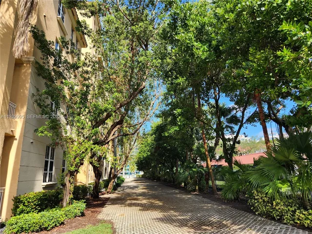 a kitchen with granite countertop a refrigerator and a stove top oven