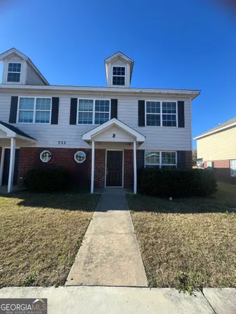 a front view of a house with a yard