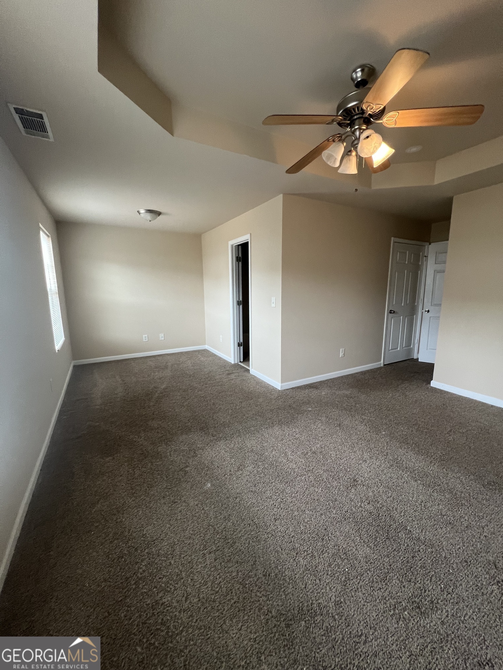 733 Wheel House Lane Monroe, GA 30655 - Photo 4 of 7 a view of an empty room and chandelier fan