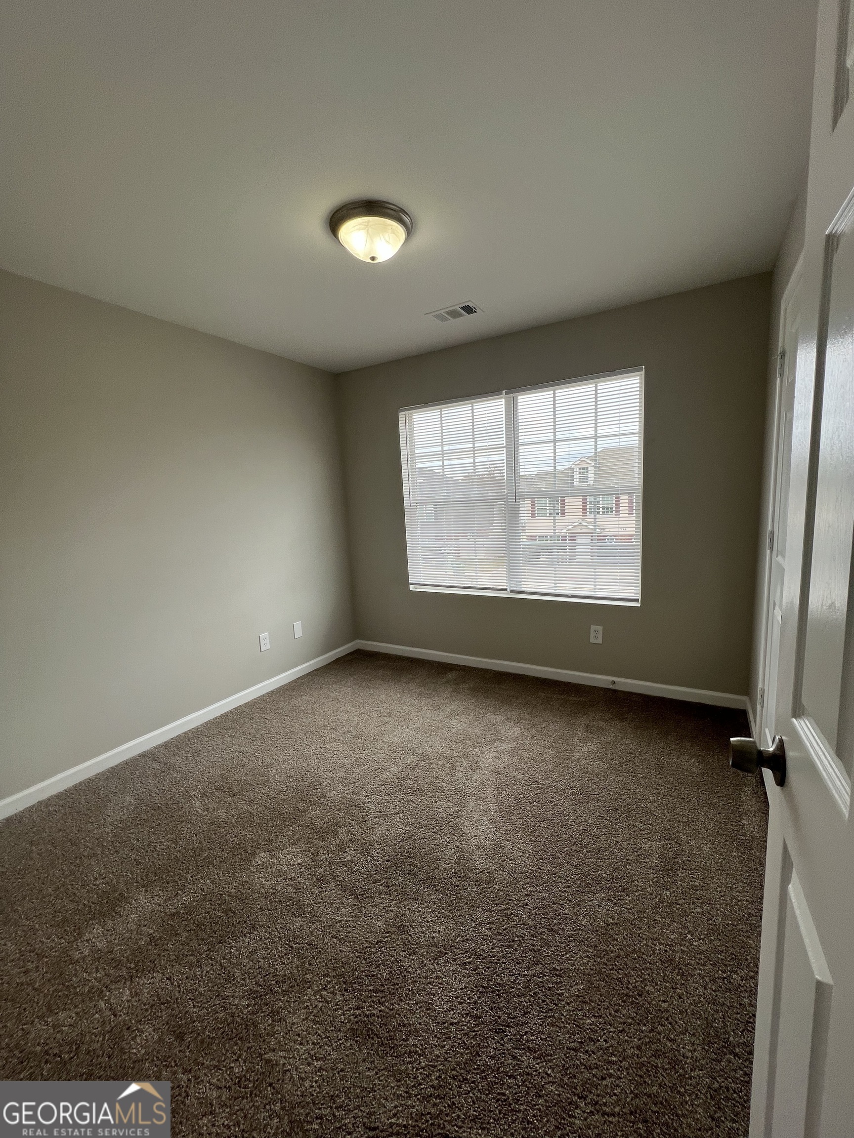 733 Wheel House Lane Monroe, GA 30655 - Photo 6 of 7 an empty room with windows