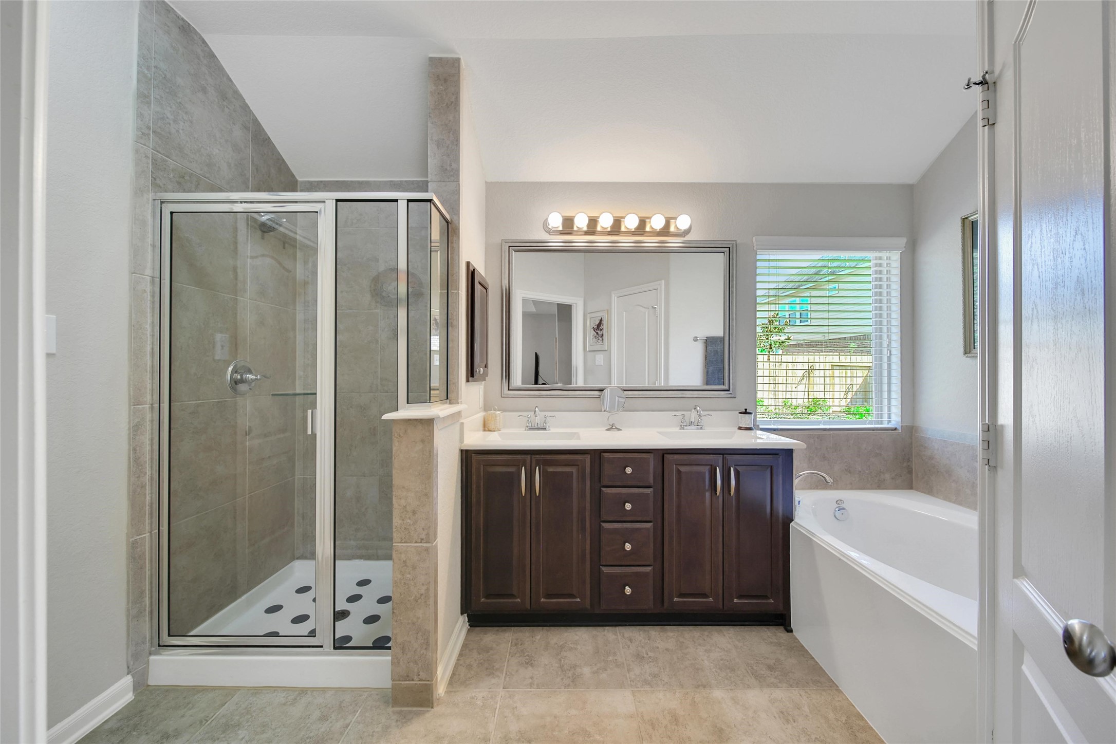 214 Pleasant Hill Way Conroe, TX 77304 - Photo 23 of 43 The en'suite bath is gorgeous with dual sinks, a glass front shower, and soaking tub.
