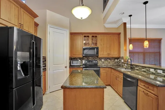 a spacious bedroom with a large bed and a chandelier