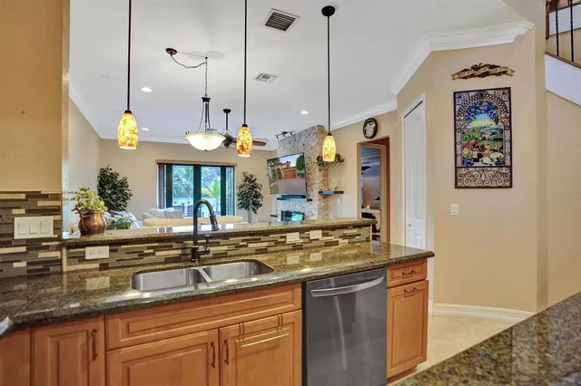 a bedroom with a bed a chandelier and a flat screen tv