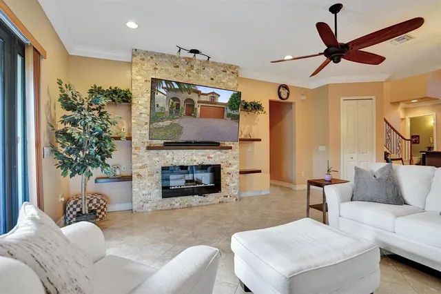 an empty room with windows and a ceiling fan