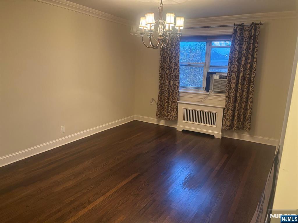 1495 Terrace Circle, Unit 6 Teaneck, NJ 07666 - Photo 11 of 16 a view of a room with wooden floor chandelier and windows