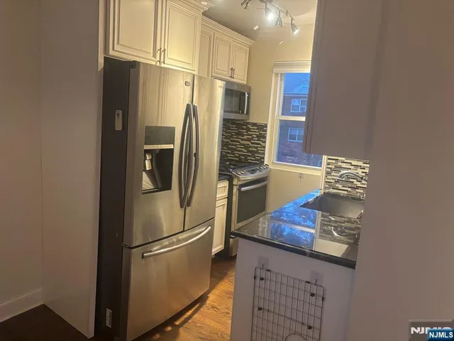 a kitchen with stainless steel appliances a refrigerator and a stove
