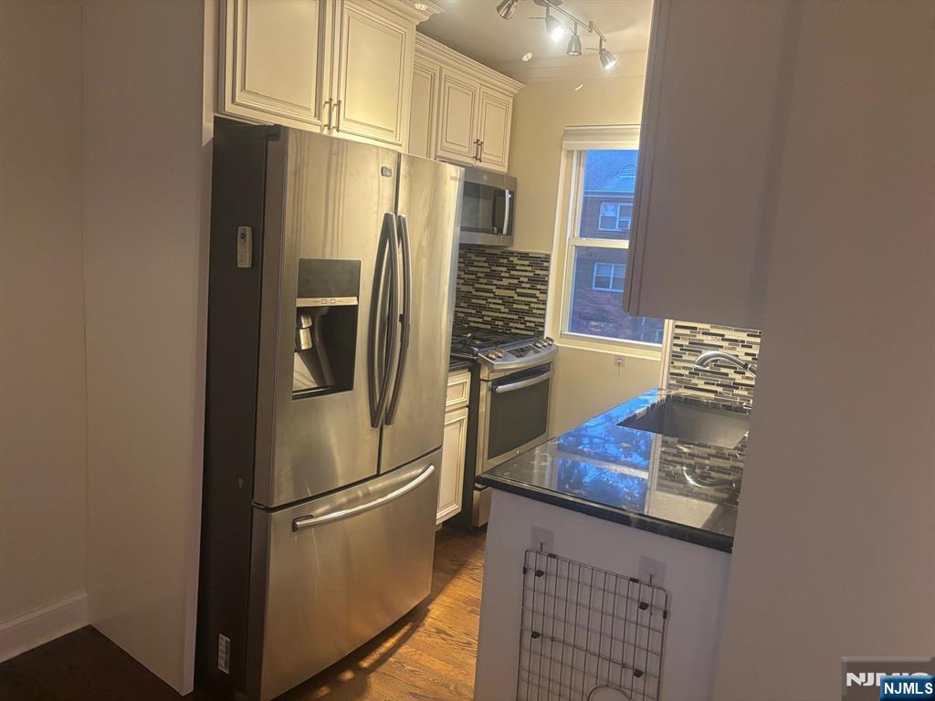 1495 Terrace Circle, Unit 6 Teaneck, NJ 07666 - Photo 14 of 16 a kitchen with stainless steel appliances a refrigerator and a stove