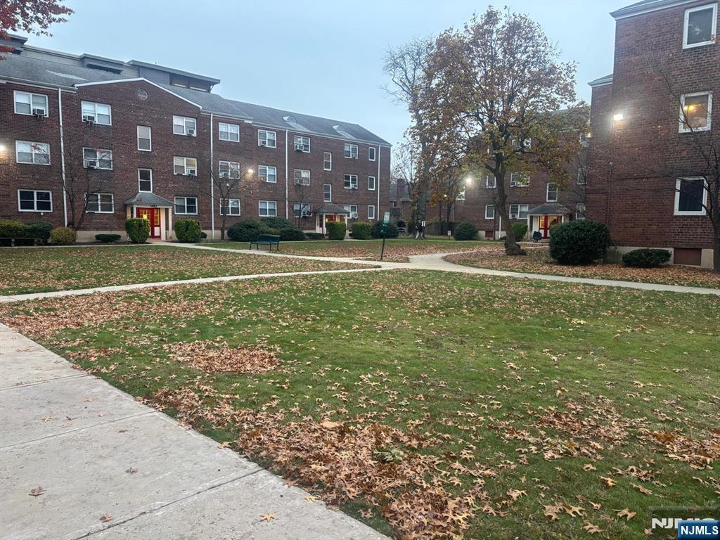 1495 Terrace Circle, Unit 6 Teaneck, NJ 07666 - Photo 2 of 16 a view of a building with a yard
