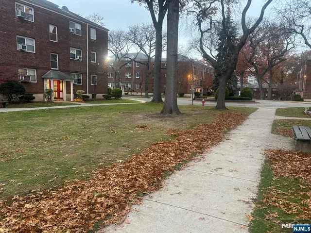 a view of a yard with a house in the background