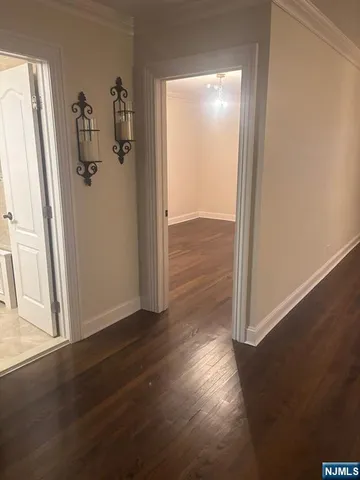 an empty room with wooden floor and closet