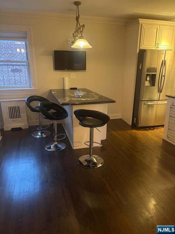 1495 Terrace Circle, Unit 6 Teaneck, NJ 07666 - Photo 6 of 16 a living room with furniture and a chandelier